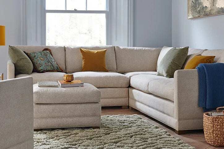 Aissa Corner Sofa Bed in modern living room with sleek design and plush cushions