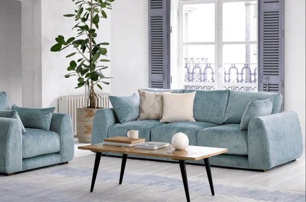 Carmel Contemporary Curved Sofa with sculptural design and plush cushions in modern living room