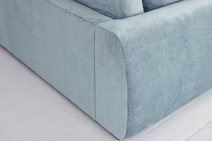 Carmel Contemporary Curved Sofa with soft curves and plush cushions in a modern living room setting