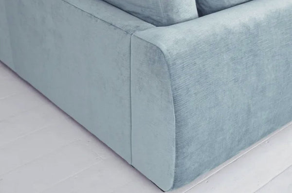 Carmel Contemporary Curved Sofa with soft curves and plush cushions in a modern living room setting