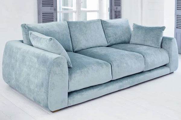 Carmel Contemporary Curved Sofa in modern living room with plush cushions and sculptural design