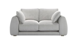 Carmel Contemporary Curved Sofa with sculptural design and plush cushions in modern living room