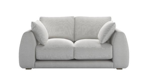 Carmel Contemporary Curved Sofa with sculptural design and plush cushions in modern living room
