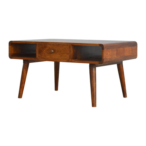 Curved chestnut coffee table made of solid mango wood with two drawers and open shelves on four Nordic style legs